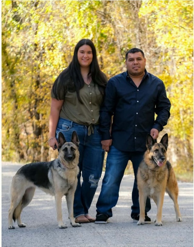 Sierra and her husband with their two German Shepherds